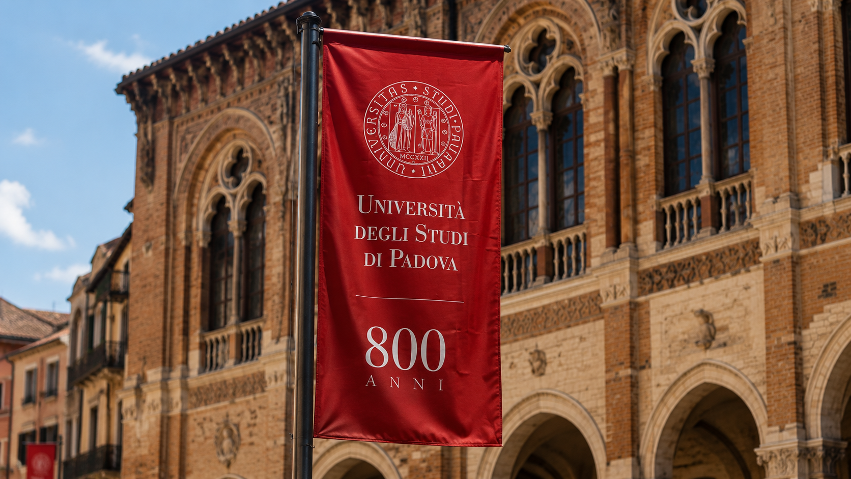 Red Università degli Studi di Padova banner outside a historic university building
